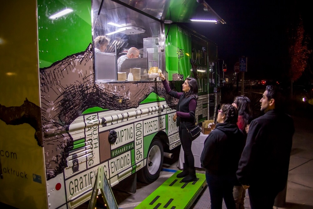 people making orders on On A Limb Food Truck at night